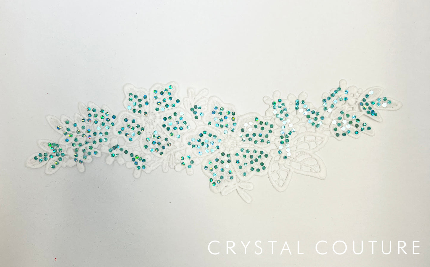 White Embroidered Floral Applique with Teal Holographic Spangles.