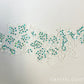 White Embroidered Floral Applique with Teal Holographic Spangles.