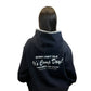 Person wearing a black hoodie with text 